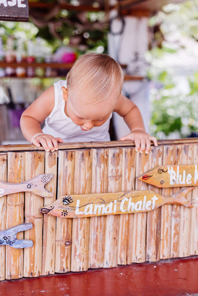 Little baby boy on vacation in thailand with social distance sign at bar. - Photo, Image