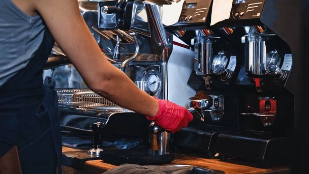 cropped view of barista holding portafilter with ground coffee - Photo, Image