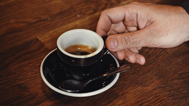 cropped view of man holding cup of espresso  - Photo, Image