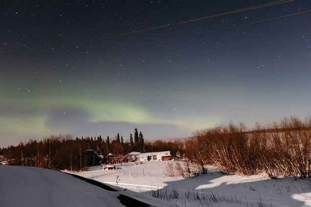 aurores boréales dans le ciel étoilé au-dessus du village. Paysage nocturne - Photo, image