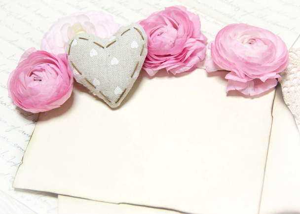 Ranunculus flowers, paper and heart background - Photo, Image