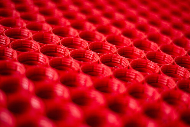 recycling plastic concept. red abstract background of plastic caps from a bottle, top view, short focus - Photo, Image
