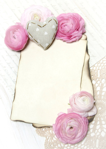 Ranunculus flowers, paper and heart background - Photo, Image