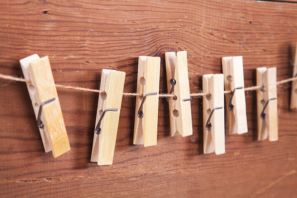 Pinzas de madera aisladas sobre un fondo de madera. - Foto, Imagen