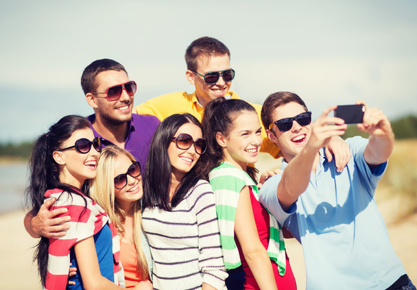 Group of friends taking picture with smartphone - Foto, Imagen