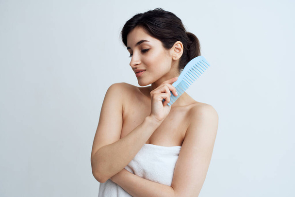 Cute brunette comb hair care naked shoulders light background - Фото, изображение