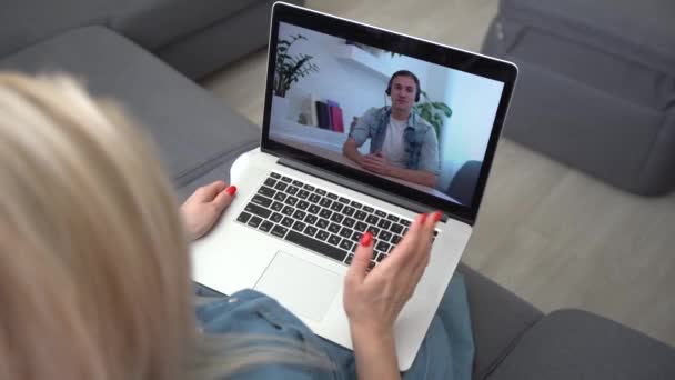 Video call. Remote work. A girl work from home. She communicate via video communication with colleagues using computer - Footage, Video