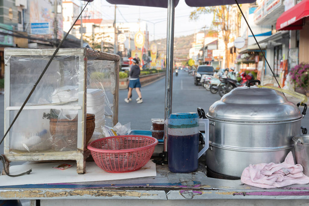 Food steamer on a cart with a blurred background of people walking on the street. - Photo, Image