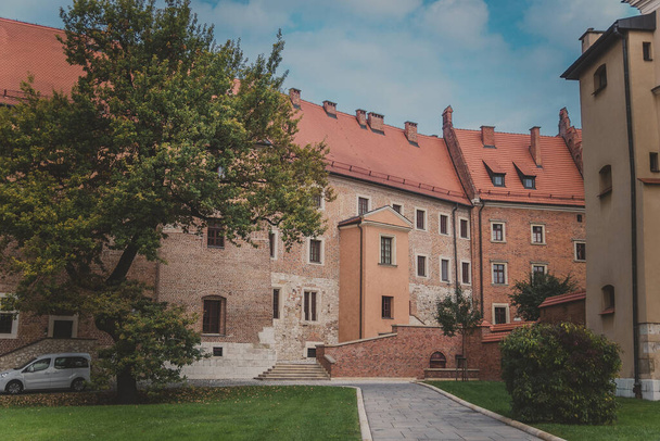View of Cathedral museum, green lawns, sidewalk, trees and bushes on Wawel Hill - Photo, Image