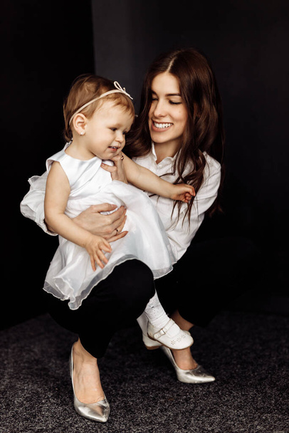 happy mother and daughter posing in studio - Photo, Image