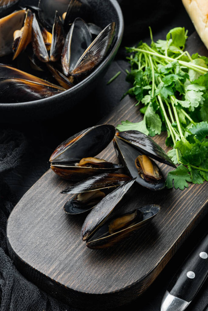 Steamed mussels in white wine set, in bowl, on black background - Photo, Image