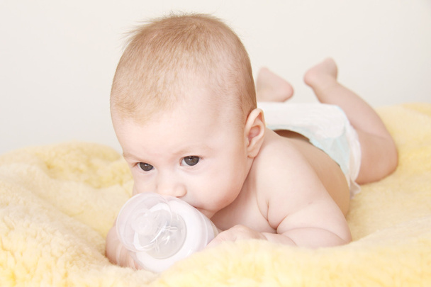 Cute baby with bottle of milk - Φωτογραφία, εικόνα