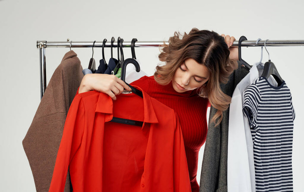 nő a boltban a ruhák szekrény piros pulóver modell - Fotó, kép