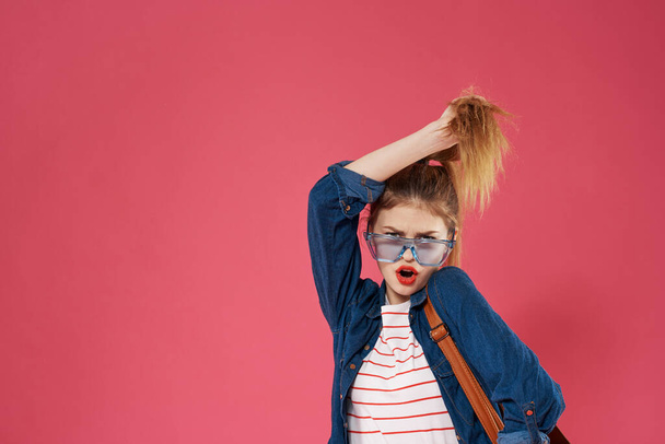 Emotional woman wearing glasses fashionable clothes backpack fun student lifestyle - Valokuva, kuva