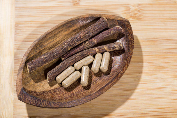 licorice root and tablets on black background - Photo, Image