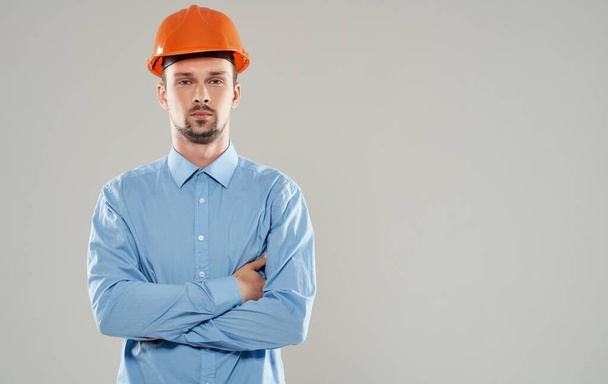 male architect in an orange helmet crossed his arms on his chest Copy Space - Foto, Bild