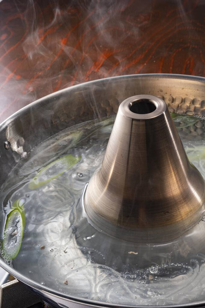 Pot boiling on stove in kitchen - Foto, afbeelding