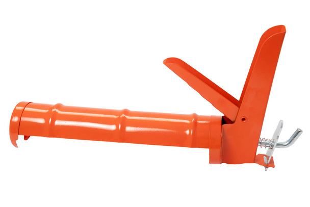 Pistolet orange pour mastic silicone isolé sur fond blanc. gros plan - Photo, image