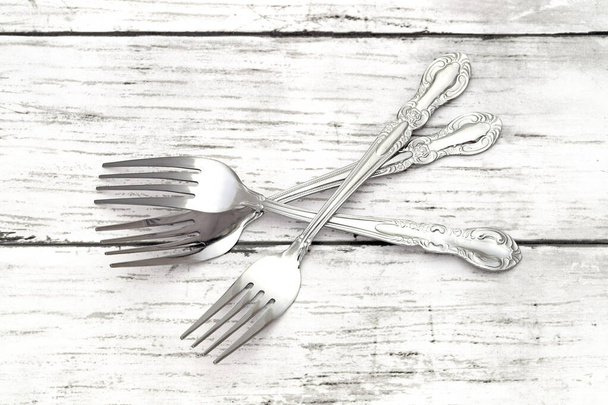 Fourchettes rétro argentées sur table en bois grunge blanche - Photo, image