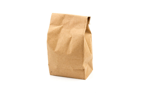 full paper disposable bag of brown kraft paper isolated on white background, concept of rejection of plastic packaging, template for designer, packaging for contactless product delivery - Photo, Image