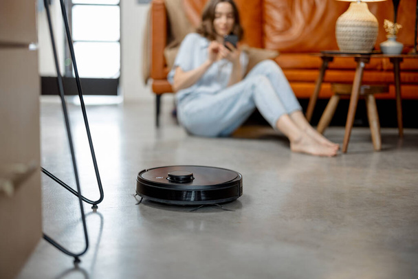 Robotic vacuum cleaner cleaning the room at home - Photo, Image