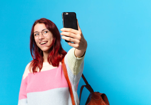 Pretty student woman using her phone - Фото, изображение