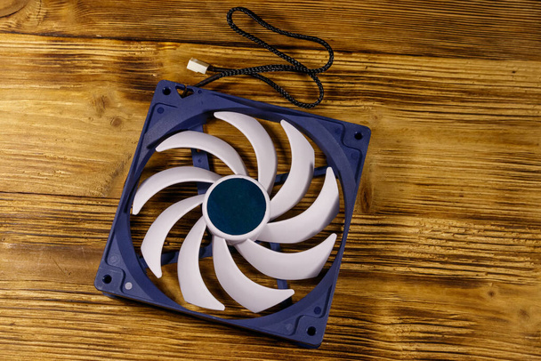 Modern computer fan on a wooden desk. Top view - Photo, Image