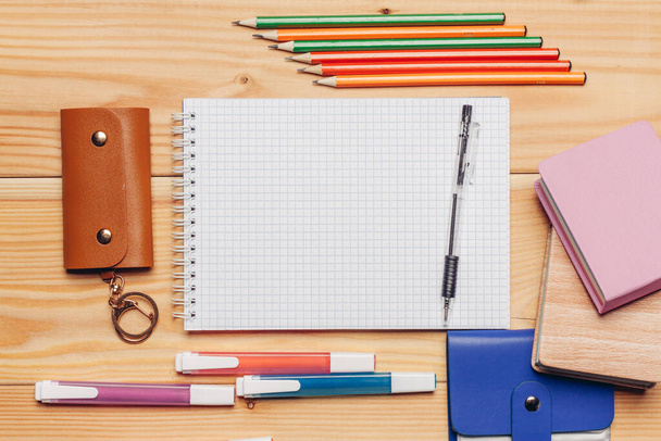 colorful paper notepads felt-tip pens stationery office wooden table - Fotoğraf, Görsel