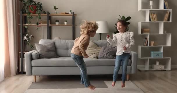 Happy two adorable little children having fun at home. - Video, Çekim