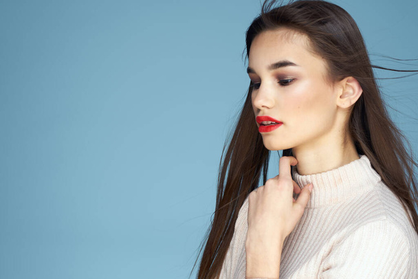 Brunette in white sweater red lips charm cropped view blue background - Φωτογραφία, εικόνα
