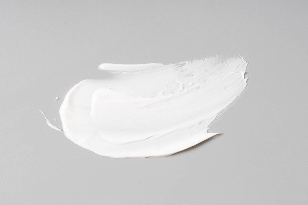 white cosmetic face cream texture on white background - Foto, imagen