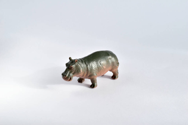 African hippopotamus. Toy for children. Small in size, brown in color. Taken from the side. Isolate. - Photo, Image