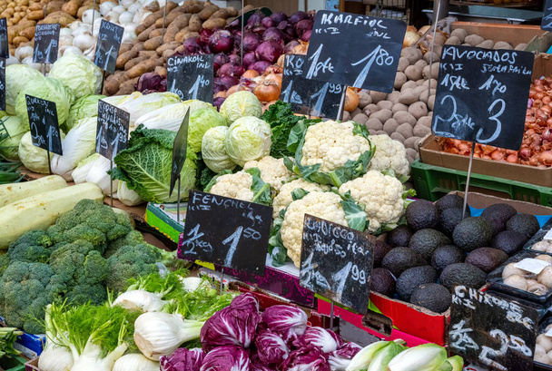 Big choice of fresh vegetables and salad for sale at a market - Photo, Image