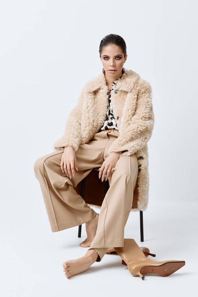 woman in fashionable clothes beige fur coat posing bright cosmetics - Photo, Image