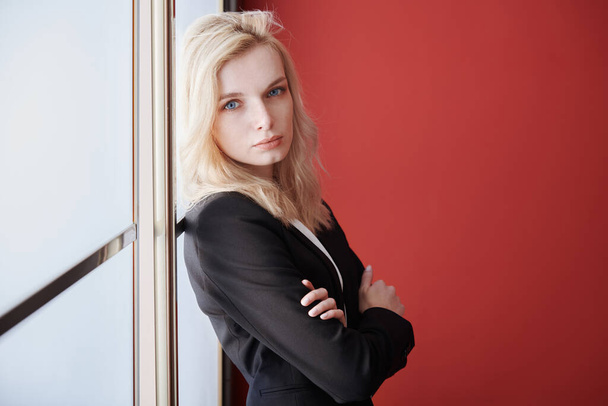 Young adult business woman standing next to the window - Zdjęcie, obraz