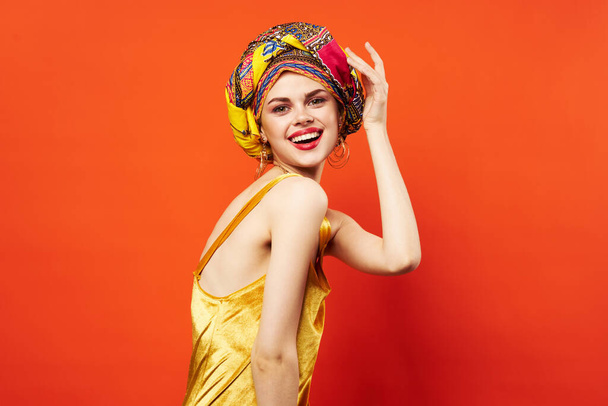 woman with multicolored turban decoration red lips charm emotions red background - Photo, Image
