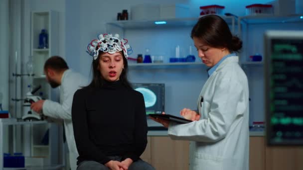 zestresowany pacjent siedzący na krześle neurologicznym z eeg słuchawkami - Materiał filmowy, wideo