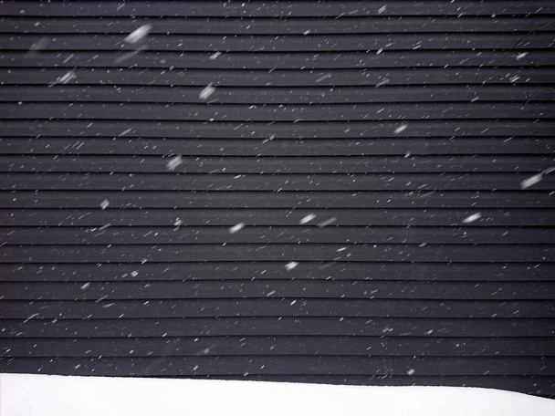 Snowflakes fly in windy weather on a black background - Photo, Image