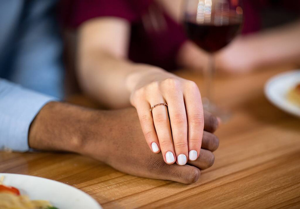 Ela disse que sim. Mão feminina com anel de noivado segurando mão de namorados negros - Foto, Imagem
