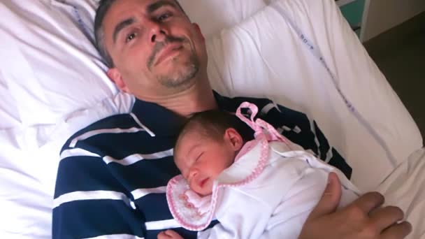 Father with newborn bay in hospital delivery room - Footage, Video