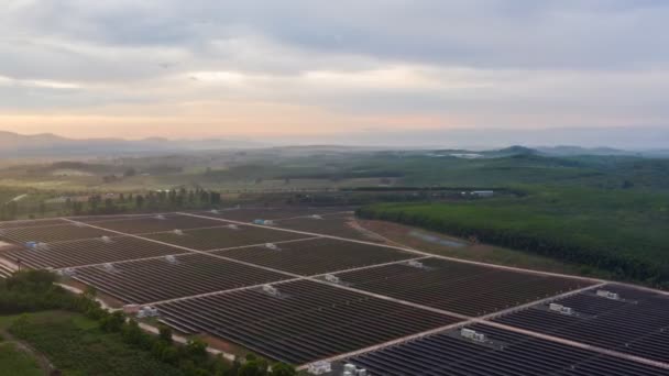 Footage B Roll of Aerial view  drone Hyperlapse Timelapse Solar cell farm at sunrise morning. Solar power plants have foggy moving slow motion through and sunlight shines on solar cell. B Roll scene. - Footage, Video