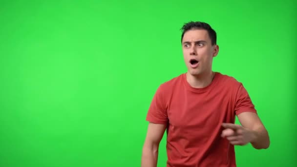 Man pointing aside, announcing something. Chroma green background. - Footage, Video