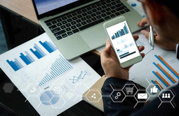 Close-up Zakenman draagt zwart hemd met smartphone om de groei van bedrijven te controleren op de beurs met gegevensstatistieken op het niveau van grafiek of grafiek.Financial Technology concept, planning en strategie - Foto, afbeelding