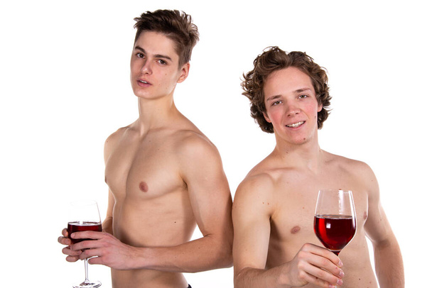 Holidays and weekends. Young attractive couple drinking red wine. White background. - Fotografie, Obrázek