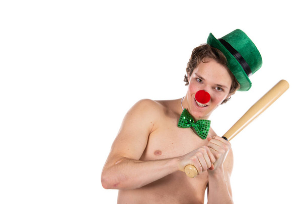 Funny guy in a clown costume. Holidays and fun. Young attractive man on a white background. - Photo, Image