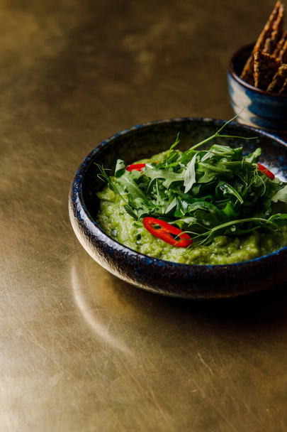 closeup view of bowl with organic healthy green sauce with arugula  - Valokuva, kuva