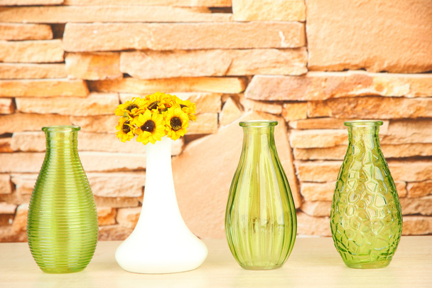 Different decorative vases on shelf on brick wall background - Фото, изображение
