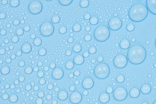 Water drops on blue background texture. Backdrop glass covered with drops of water. bubbles in water - Photo, Image