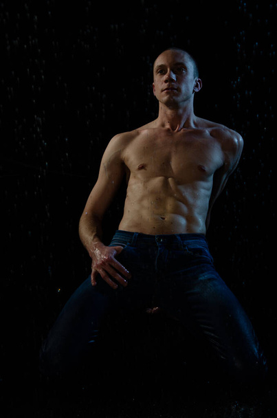 A Handsome young man under the shower dripping wet. - 写真・画像