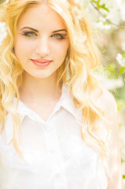 Spring portrait of a beautiful young blonde woman. - Photo, Image